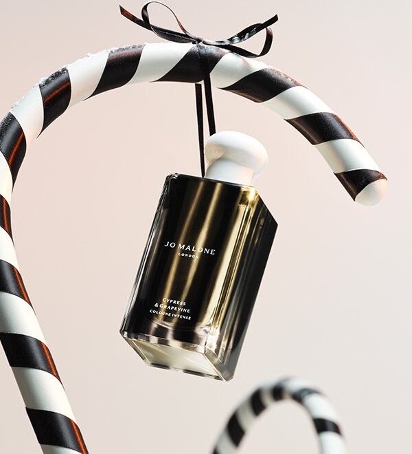 Jo Malone London Christmas Cypress and grapevine cologne on black and white candy cane