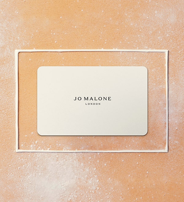 Jo Malone London Christmas Cypress and grapevine cologne on black and white candy cane
