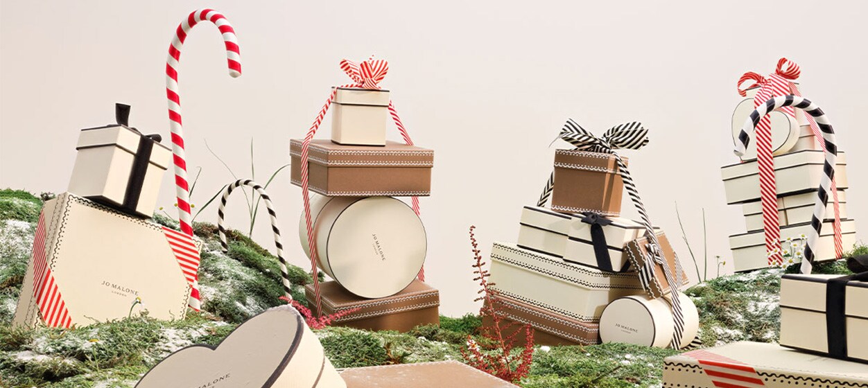 Jo Malone London Collection stacked on a bed of moss with candy canes