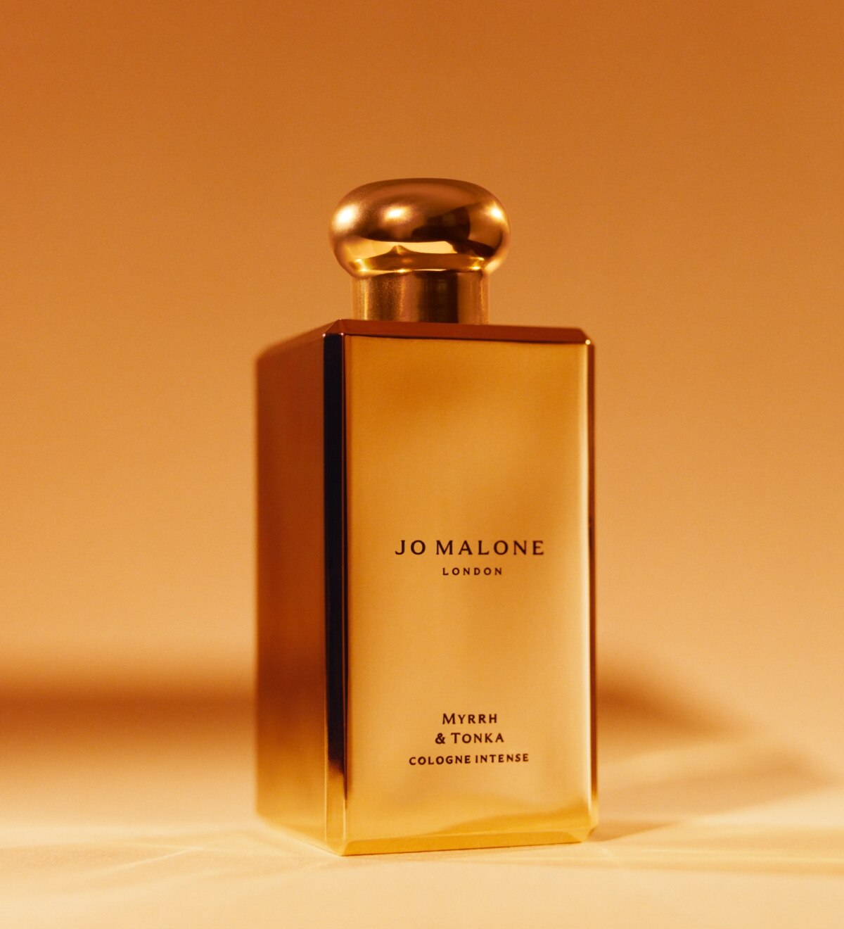Jo Malone London myrrh & tonka in a special edition gold bottle with gold background