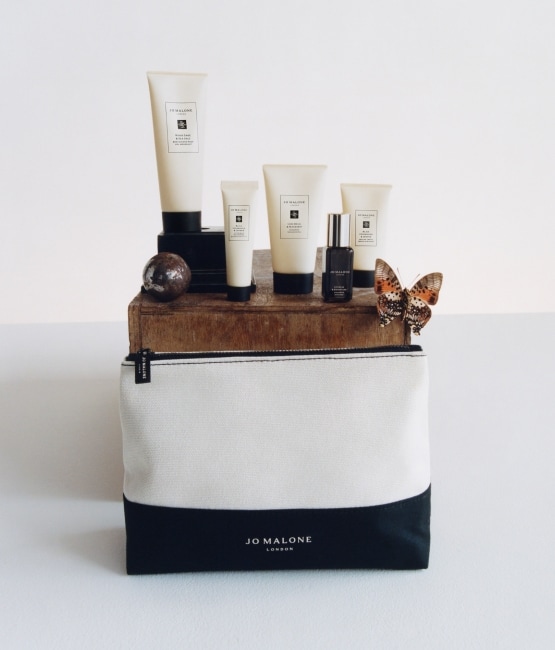 Men's Travel Grooming Kit with black and cream pouch and products standing behind