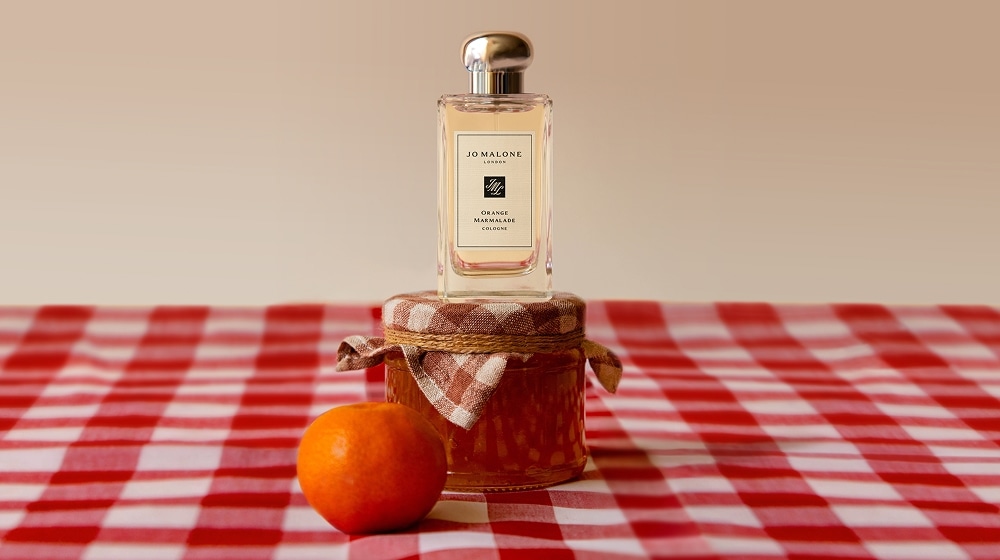 Orange Marmalade Cologne on Marmalade Jar on red gingham tablecloth