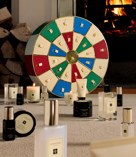 Jo Malone London Advent Calendar next to fireplace and all products sitting in front