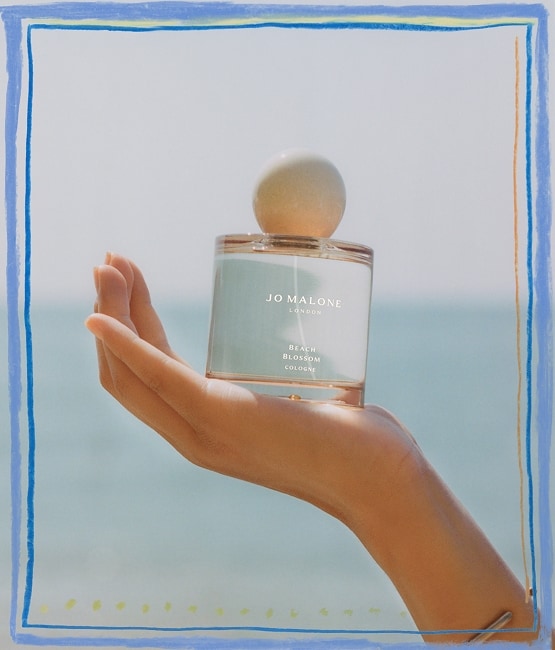 Jo Malone London | Beach Setting with woman's hand holding a cologne