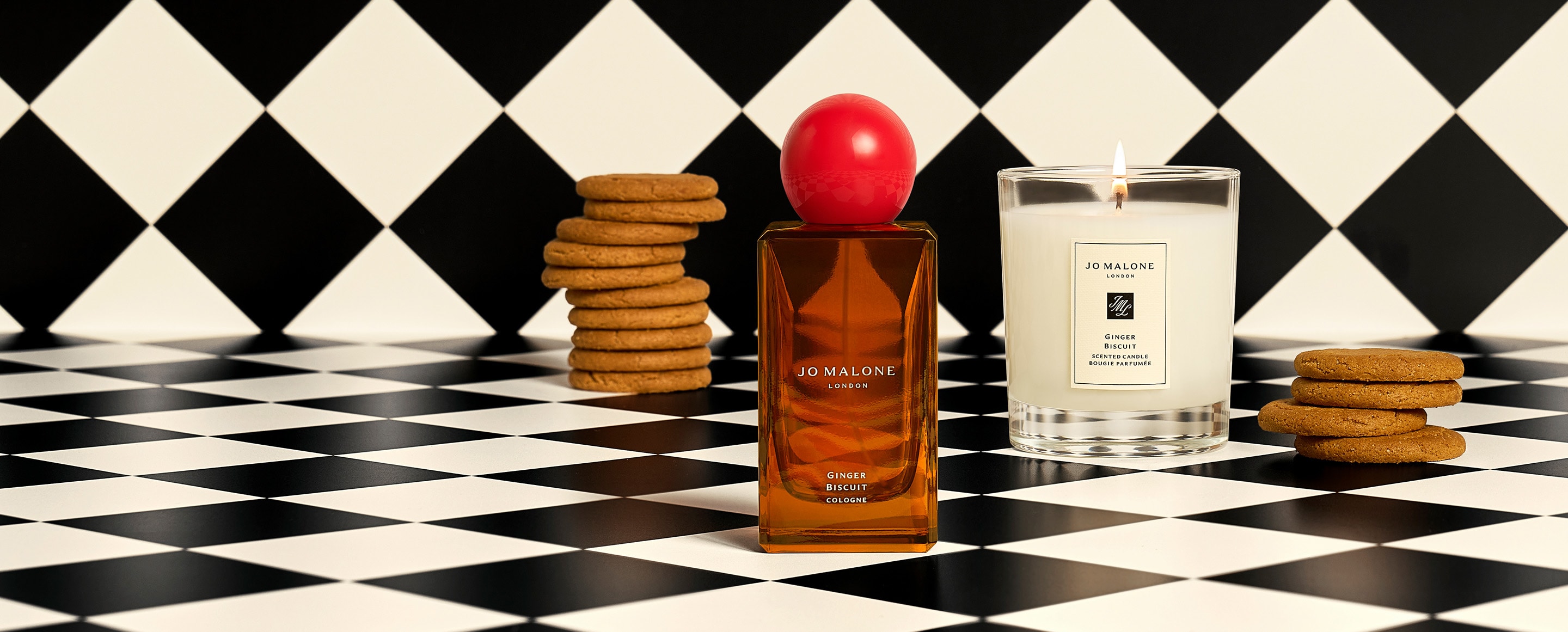 Jo Malone London Ginger Biscuit Cologne and Candle surrounded by ginger biscuits