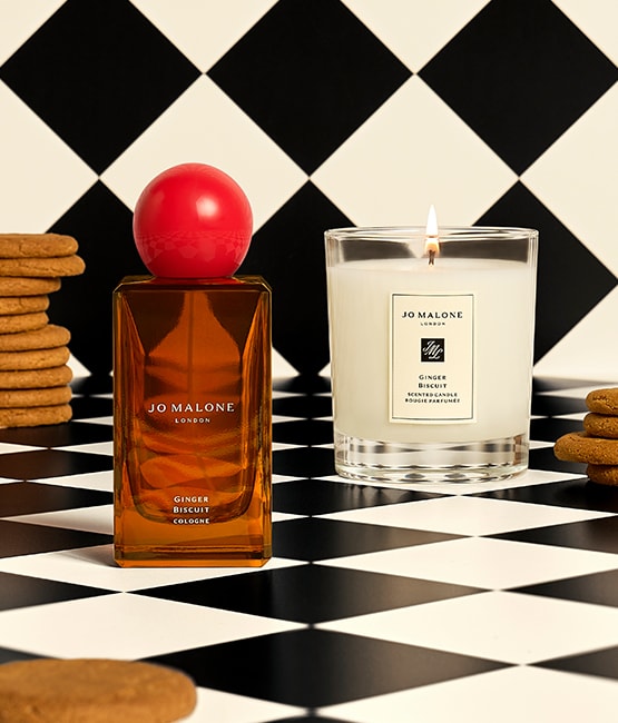 Jo Malone London Ginger Biscuit Cologne and Candle surrounded by ginger biscuits