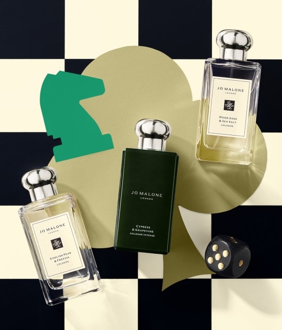 Cologne and Cologne Intense on checkered background with dice and chess piece 