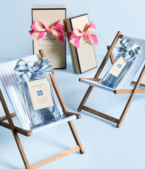 Special-Edition Wood Sage & Sea Salt Cologne sit on mini deckchairs with Jo Malone London Boxes behind