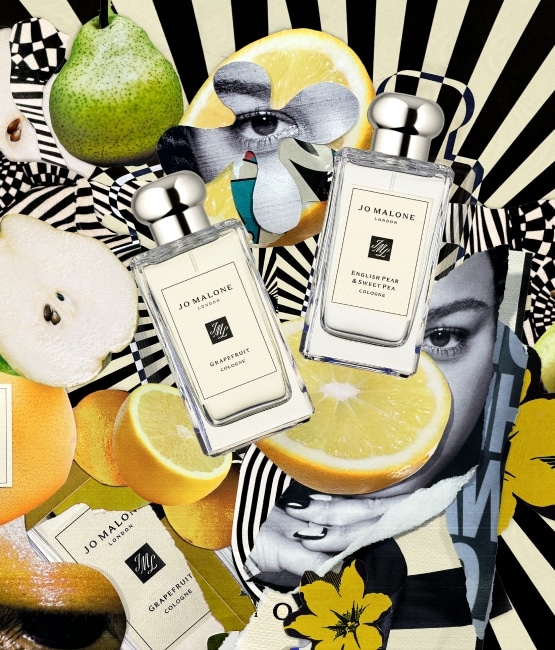 Person with Jo Malone London bottles, pears, and flowers on a black-and-white striped background.