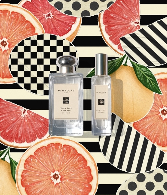 Person with Jo Malone London bottles, pears, and flowers on a black-and-white striped background.