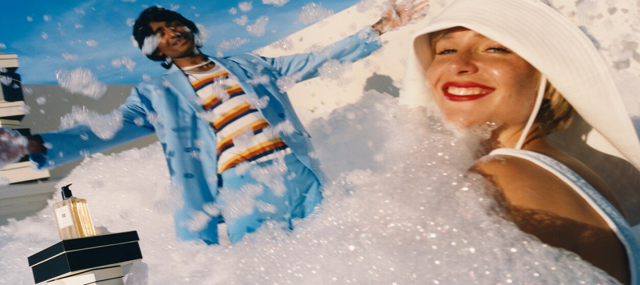 image of two people surrounded by foam with a luxury body and hand wash 