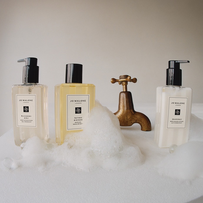 Bestselling hand and body wash, bath oil and lotion surrounded by bubbles