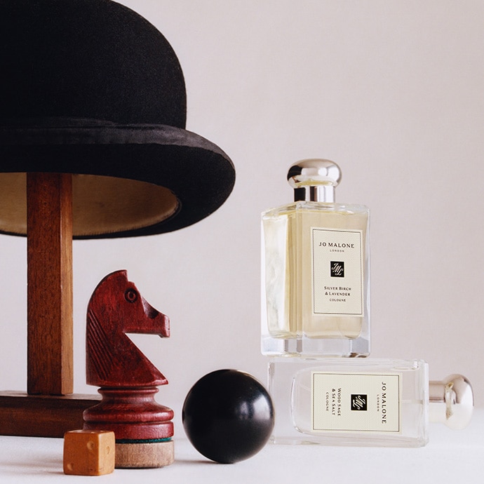 Bestselling men's cologne placed next to hat stand and wooden chess pieces