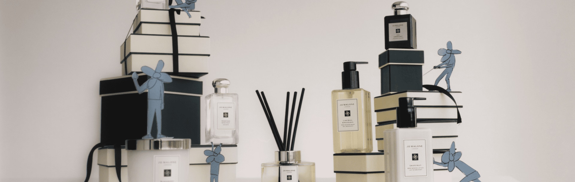 image of multiple products from bath and body, home and cologne sat on jo malone cream and black boxes
