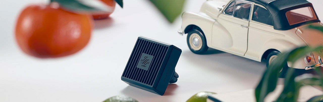 image of mini toy car next to a jo malone car diffuser surrounded by mandarins & limes