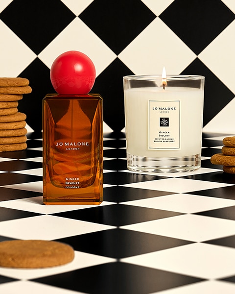 Ginger Biscuit Cologne and Candle surrounded by ginger biscuits on checkered background